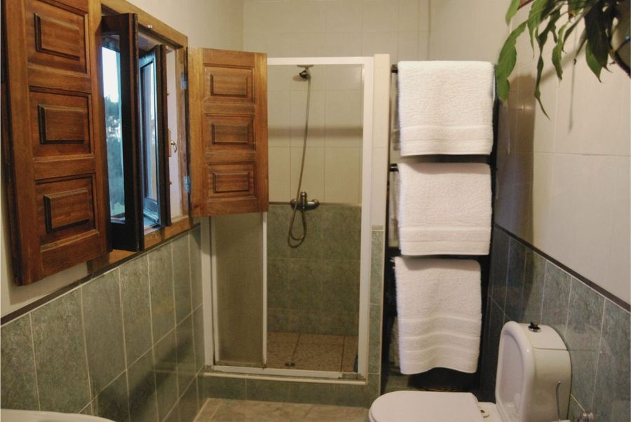 The bathroom — shuttered windows with long views across the valley
